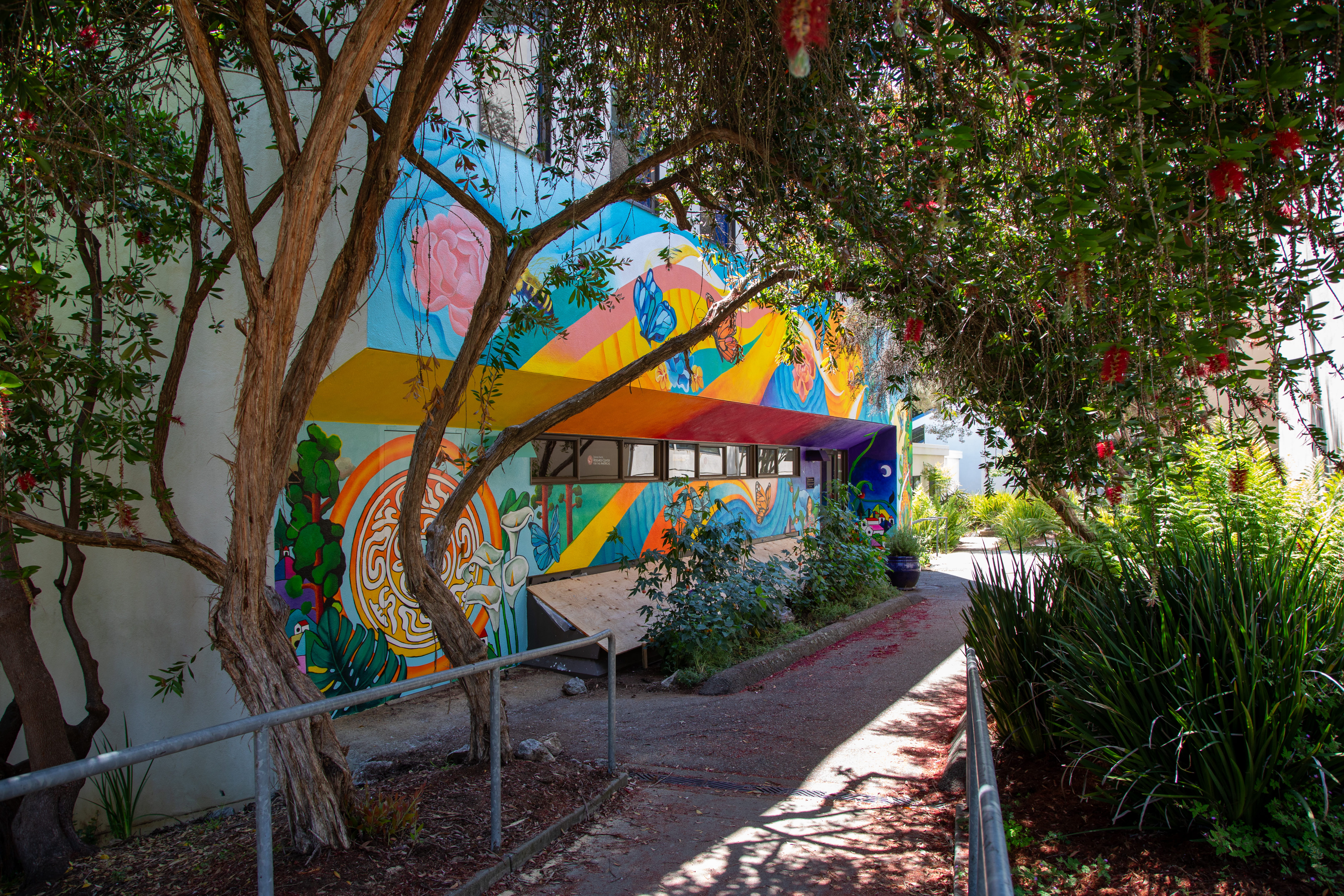 Wide shot of Casa Latina exterior with bright mural of butterflies