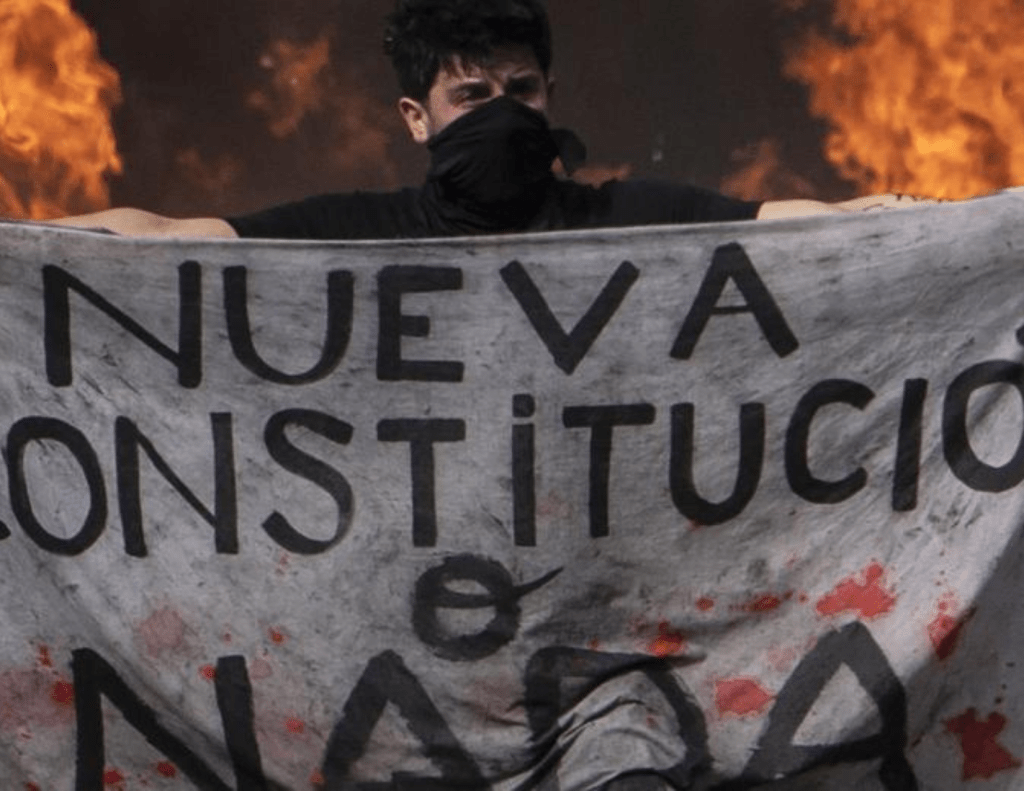 Chilean protestor holding banner