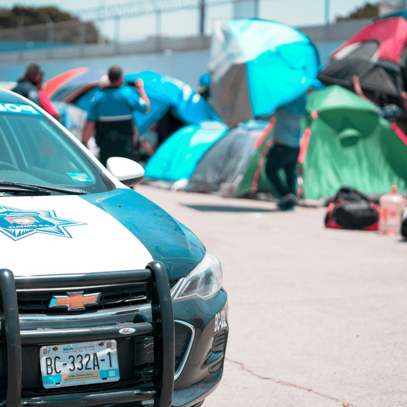 police car in baja california in front of tents