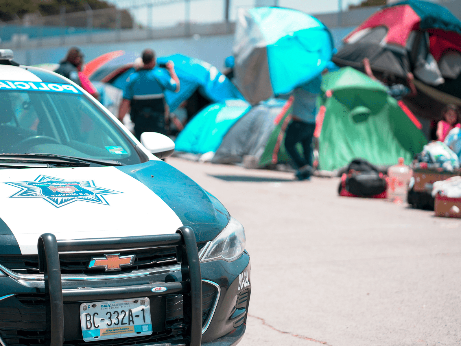 Image of police car in front of tents on the street in Baja California